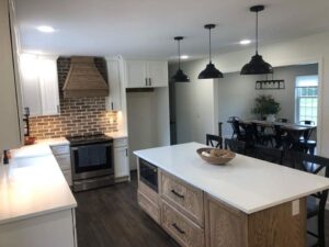 qualified remodelers newly remodeled kitchen with hardwood floors and sleek white countertops